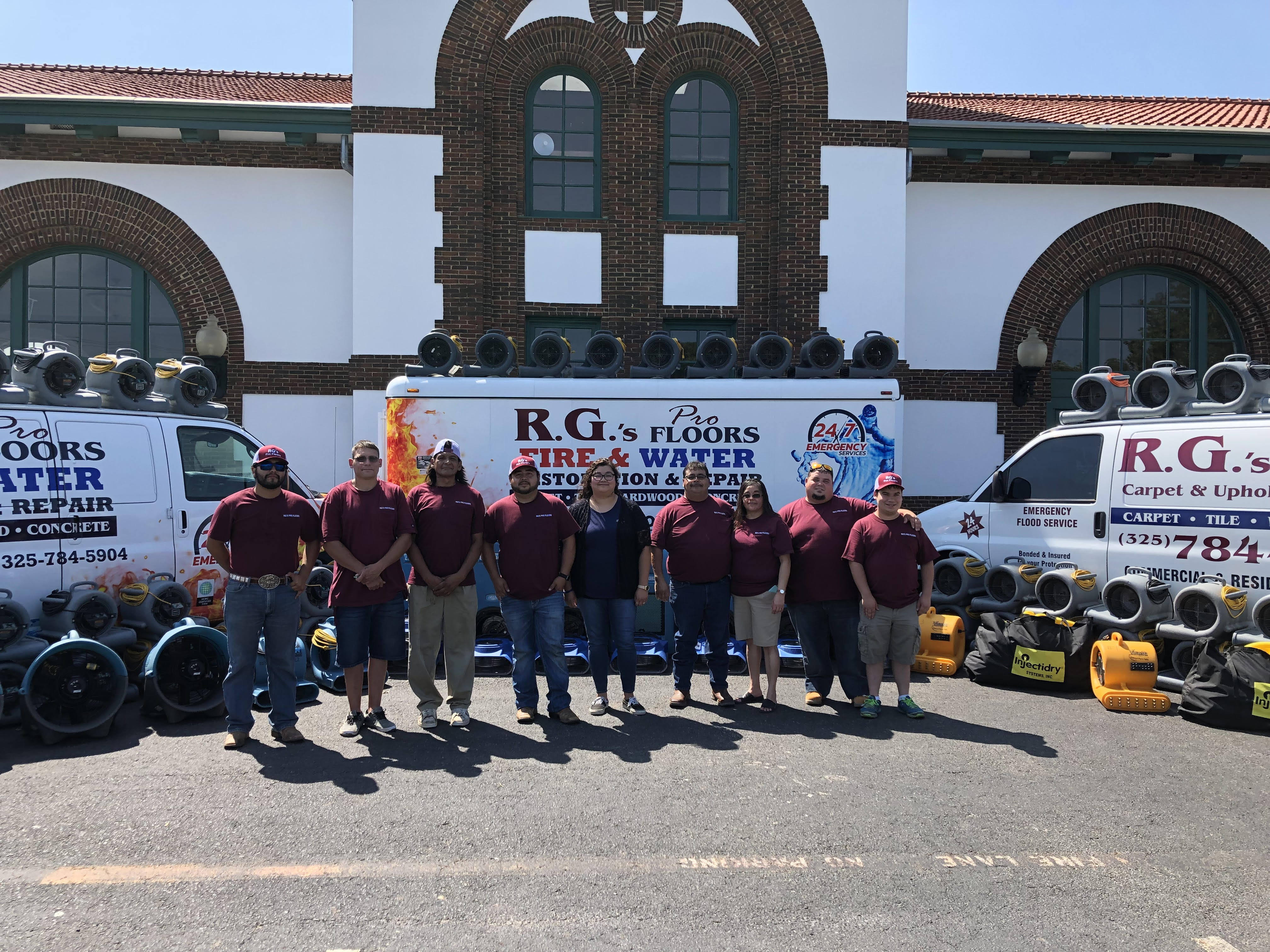 The R.G. Pro Floors team standing in front of their branded service vans and restoration equipment in Brownwood, TX